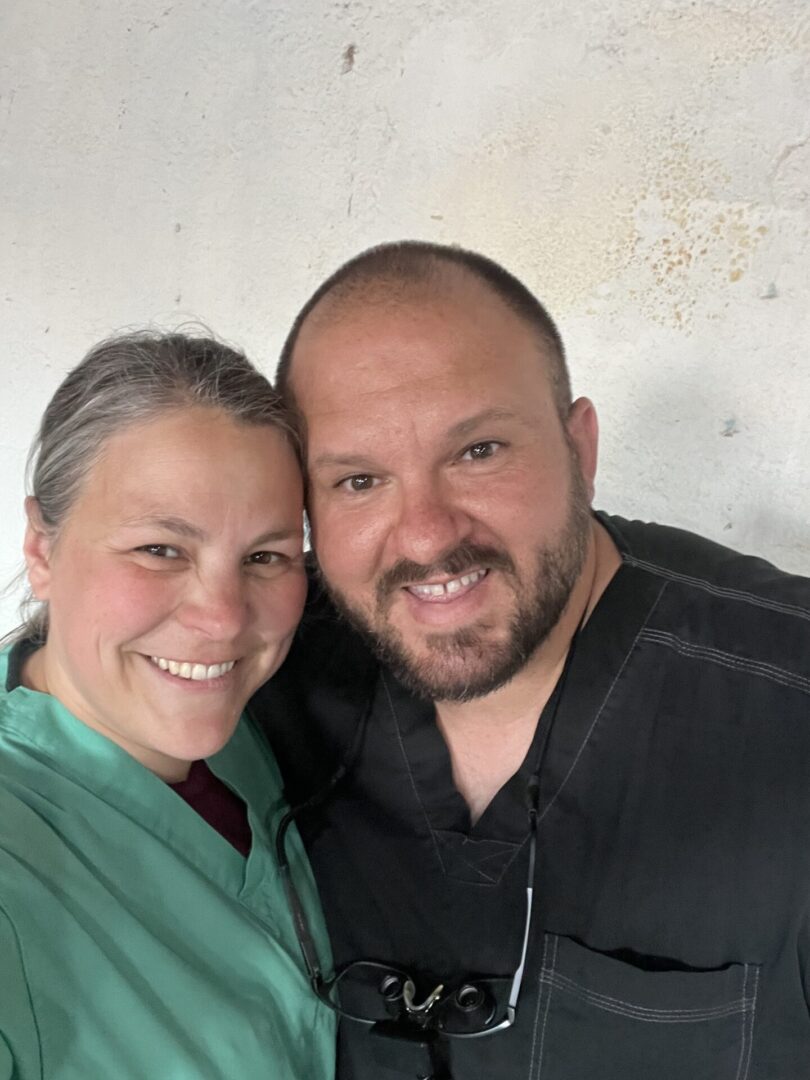 Smiling couple posing for a close-up photo indoors.