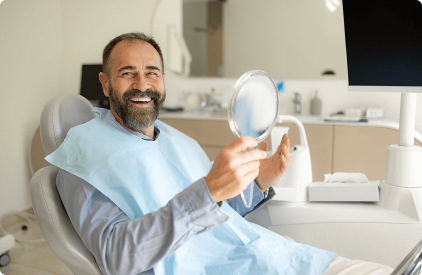 Patient holding dental mirror