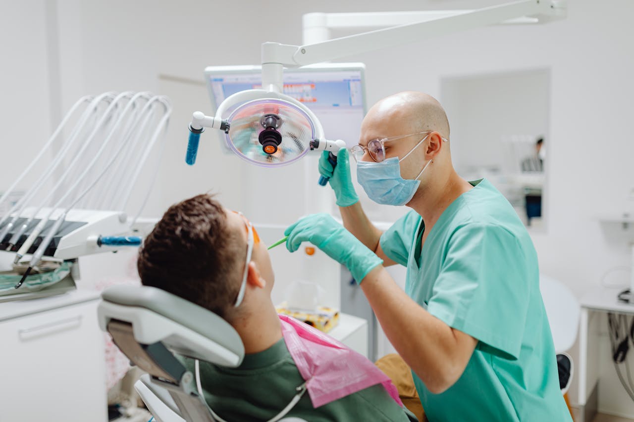 Dentist examining patient's teeth in a modern clinic.